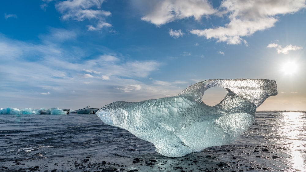 white ice on gray sand during daytime