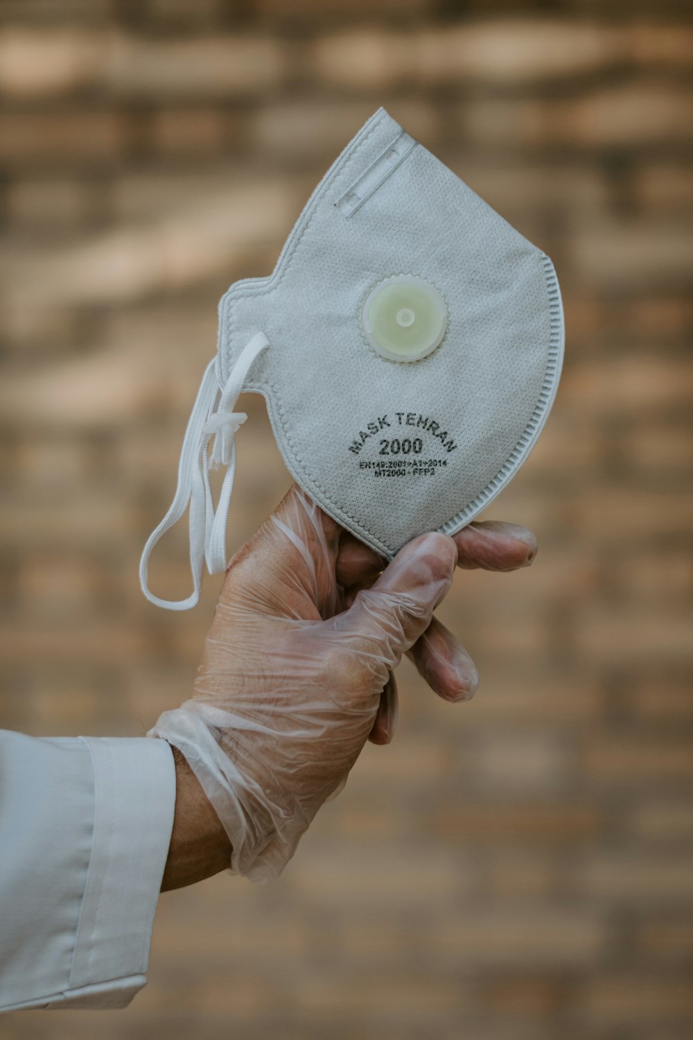 person holding white and yellow cap