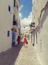 2 men walking on street during daytime