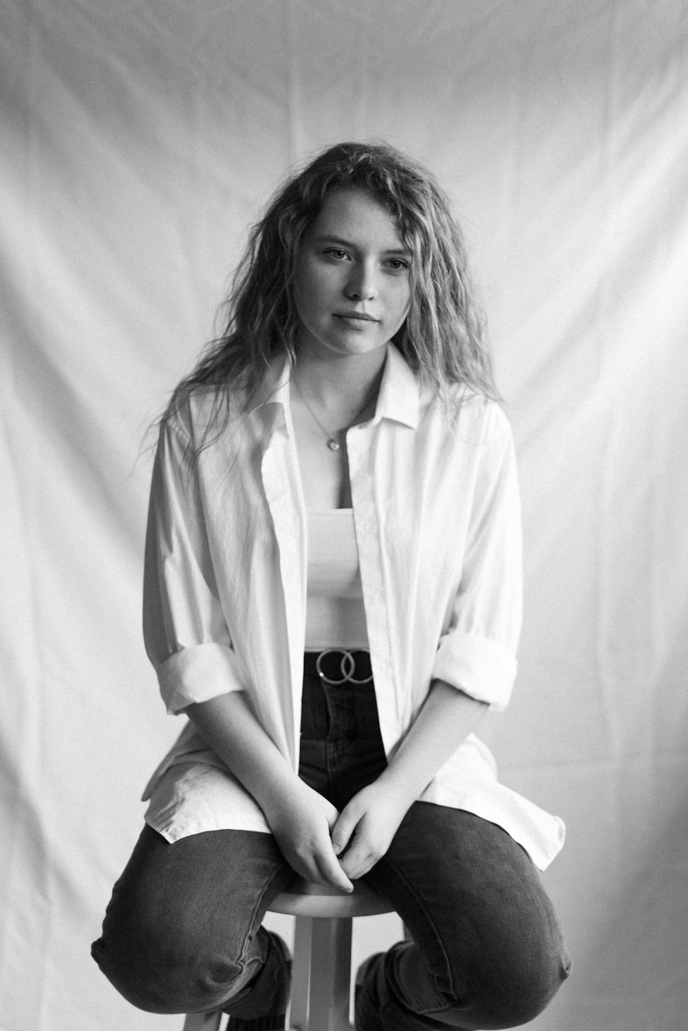 woman in white coat sitting on the floor