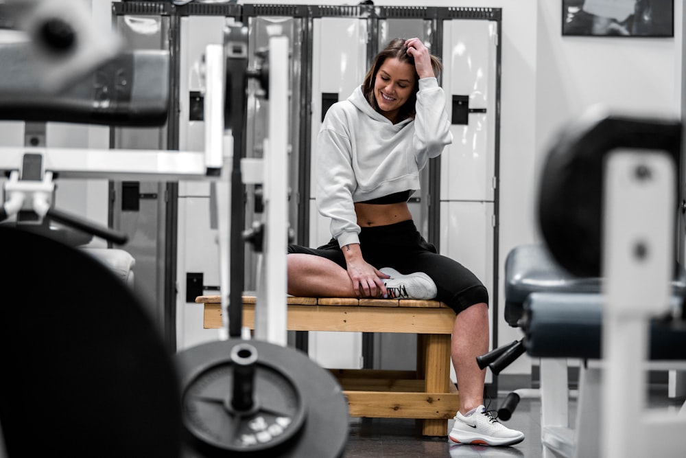 woman in white long sleeve shirt sitting on black and brown bench