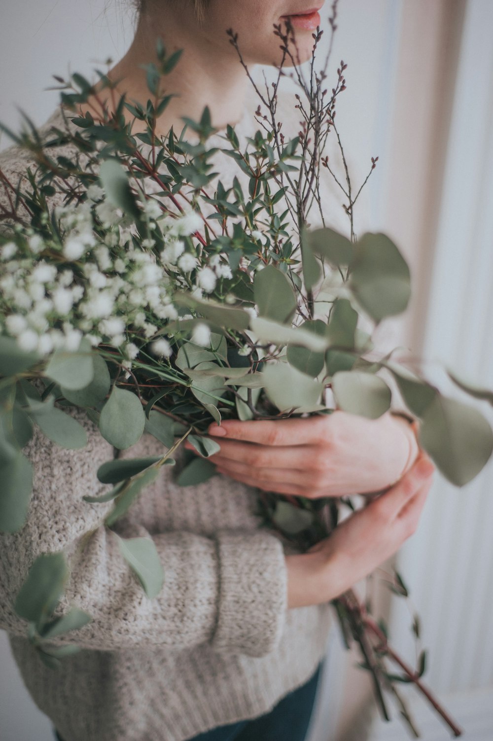 person holding white flower bouquet