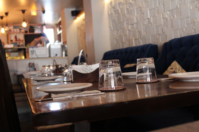 A warm, inviting dining area with rustic wooden tables and colorful soul food dishes beautifully plated.