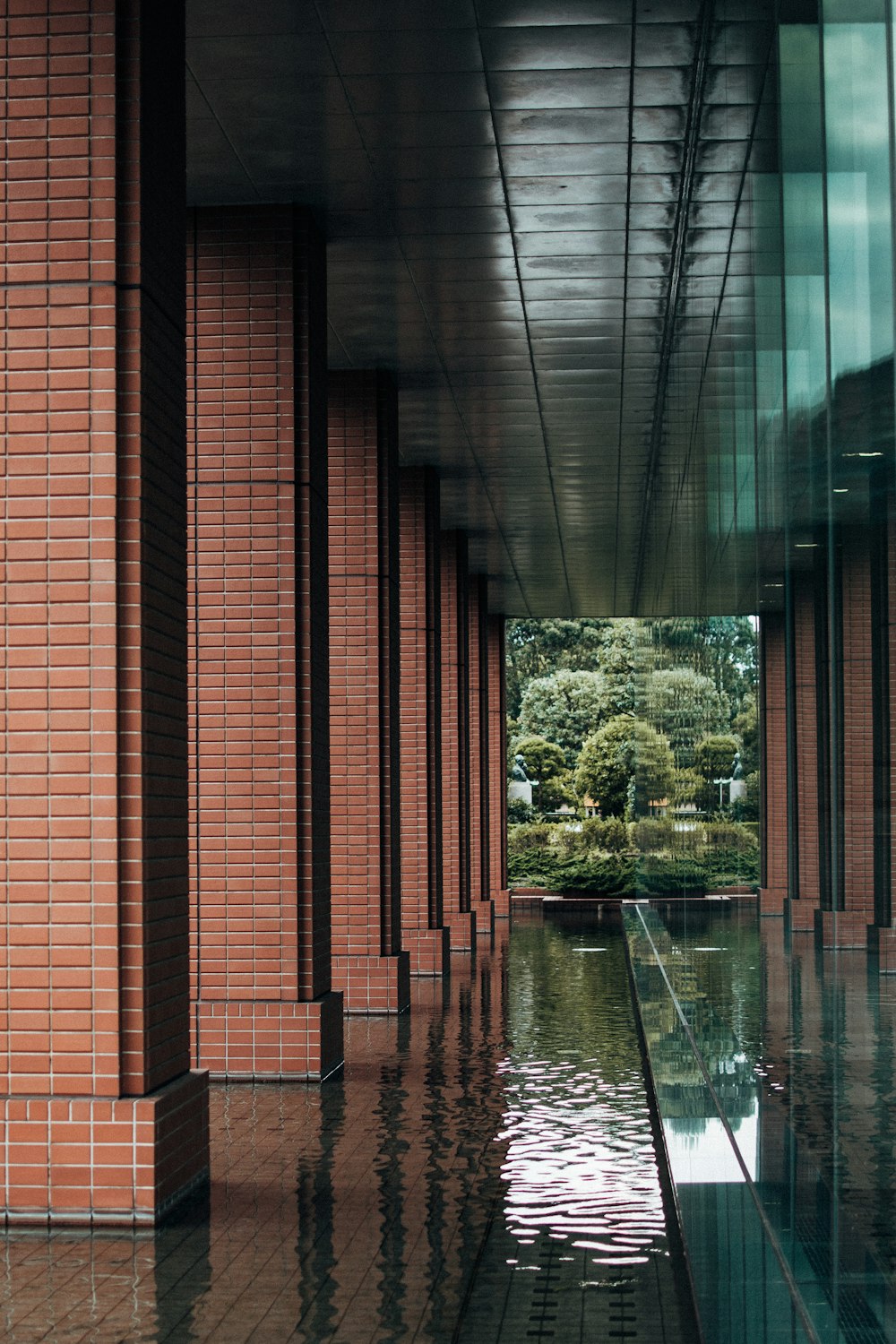 brown brick building with green trees