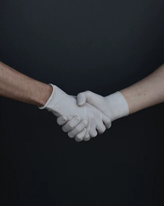 person holding white heart shaped paper