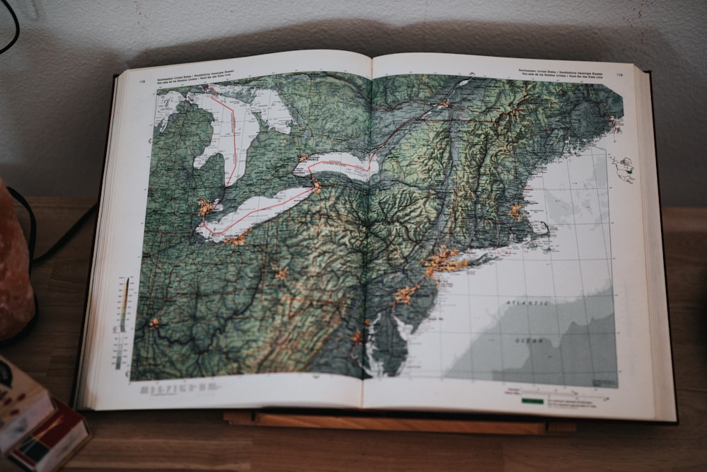 white and green map on brown wooden table