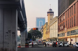 people walking on street near beige concrete building during daytime