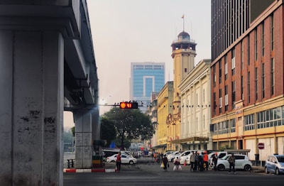 people walking on street near beige concrete building during daytime