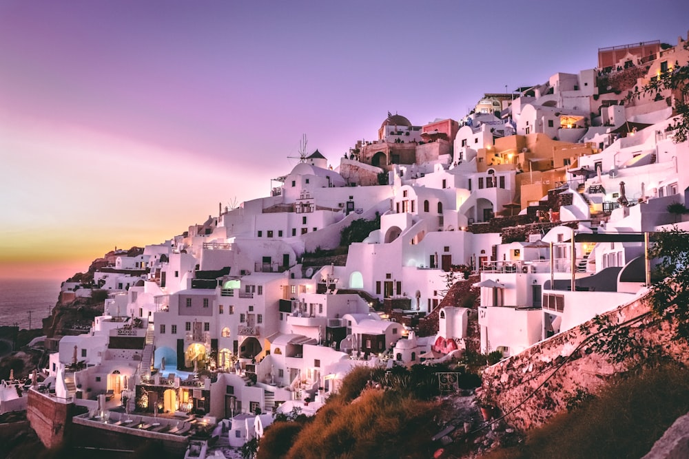 white concrete houses on hill during daytime