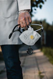 person in blue denim jeans with gray and black metal padlock