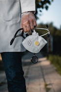 person in blue denim jeans with gray and black metal padlock