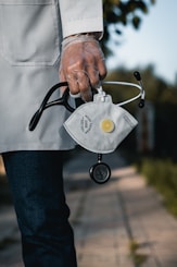 person in blue denim jeans with gray and black metal padlock