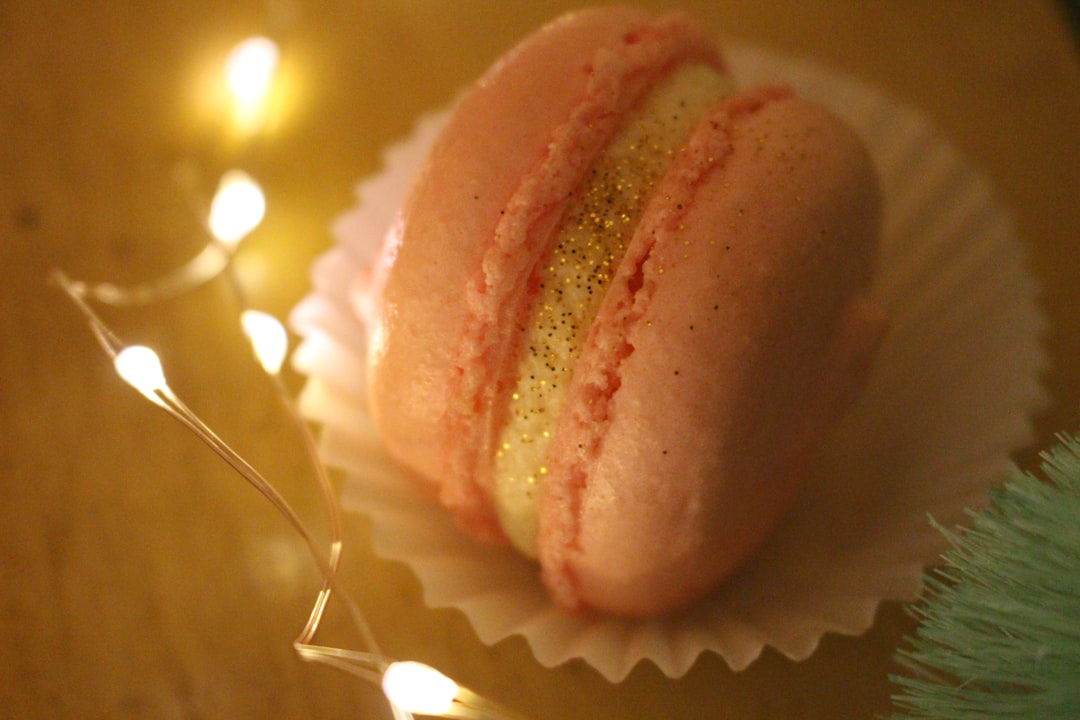 pink and brown pastry on white ceramic plate, pink glittery macaron with fairy lights