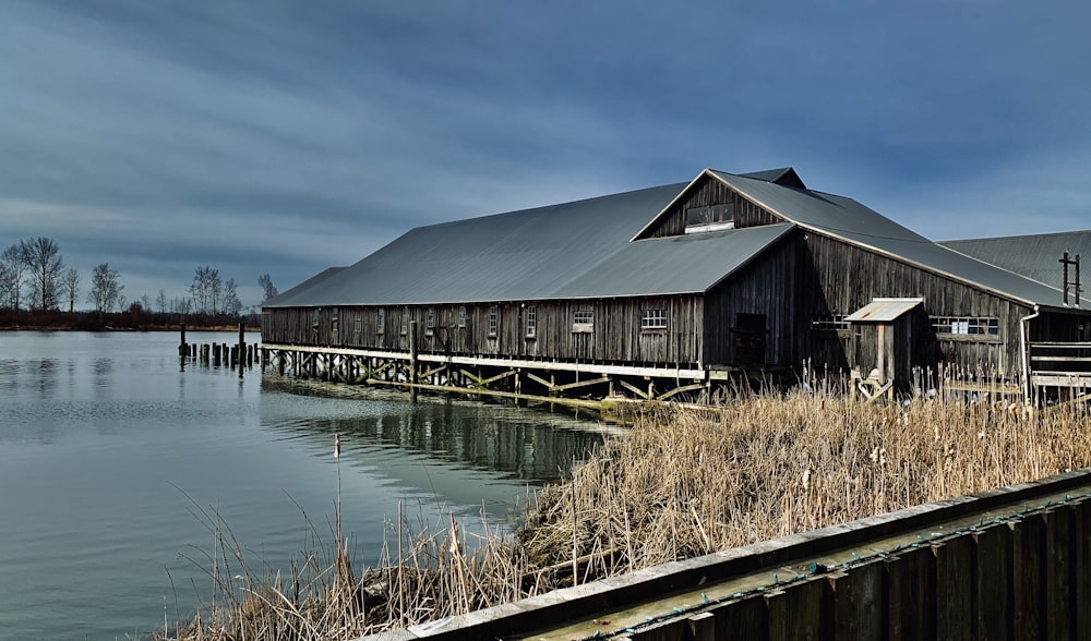 brown wooden house on body of water during daytime