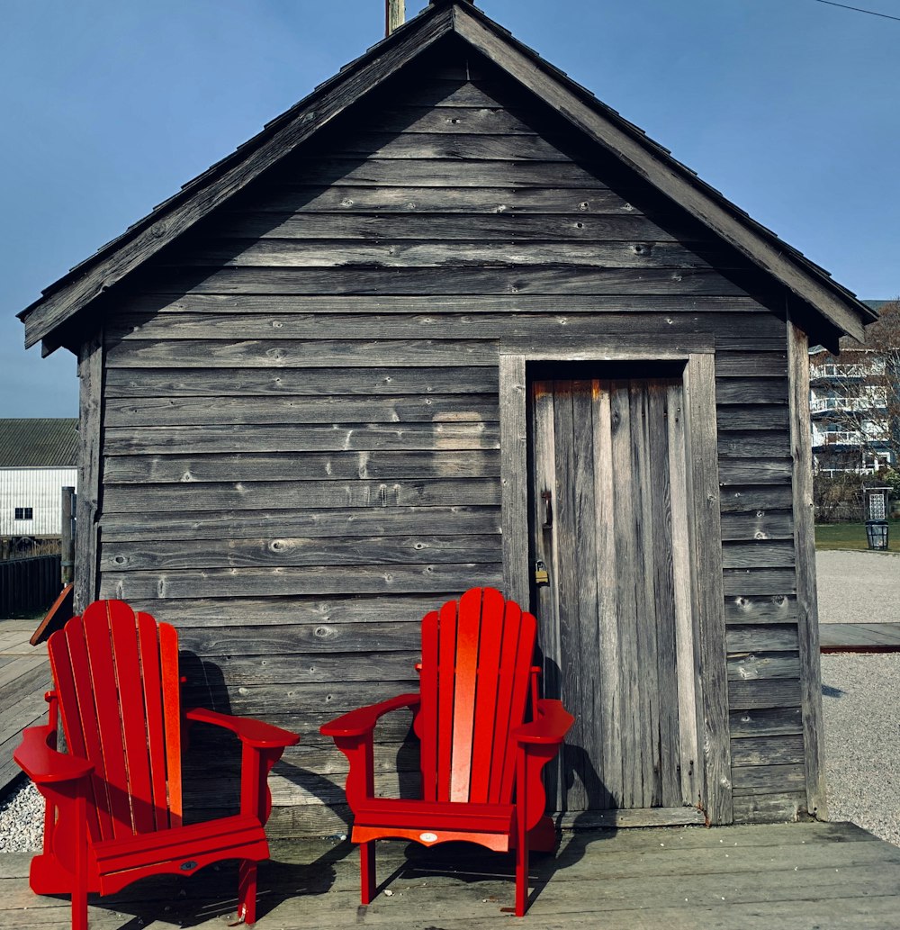 red wooden chairs near brown wooden house