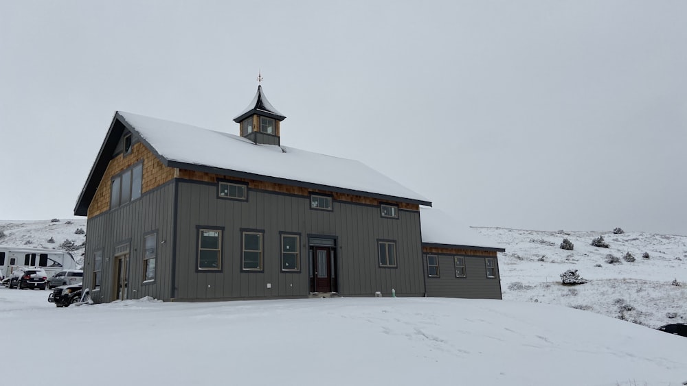 brown and white wooden house on snow covered ground