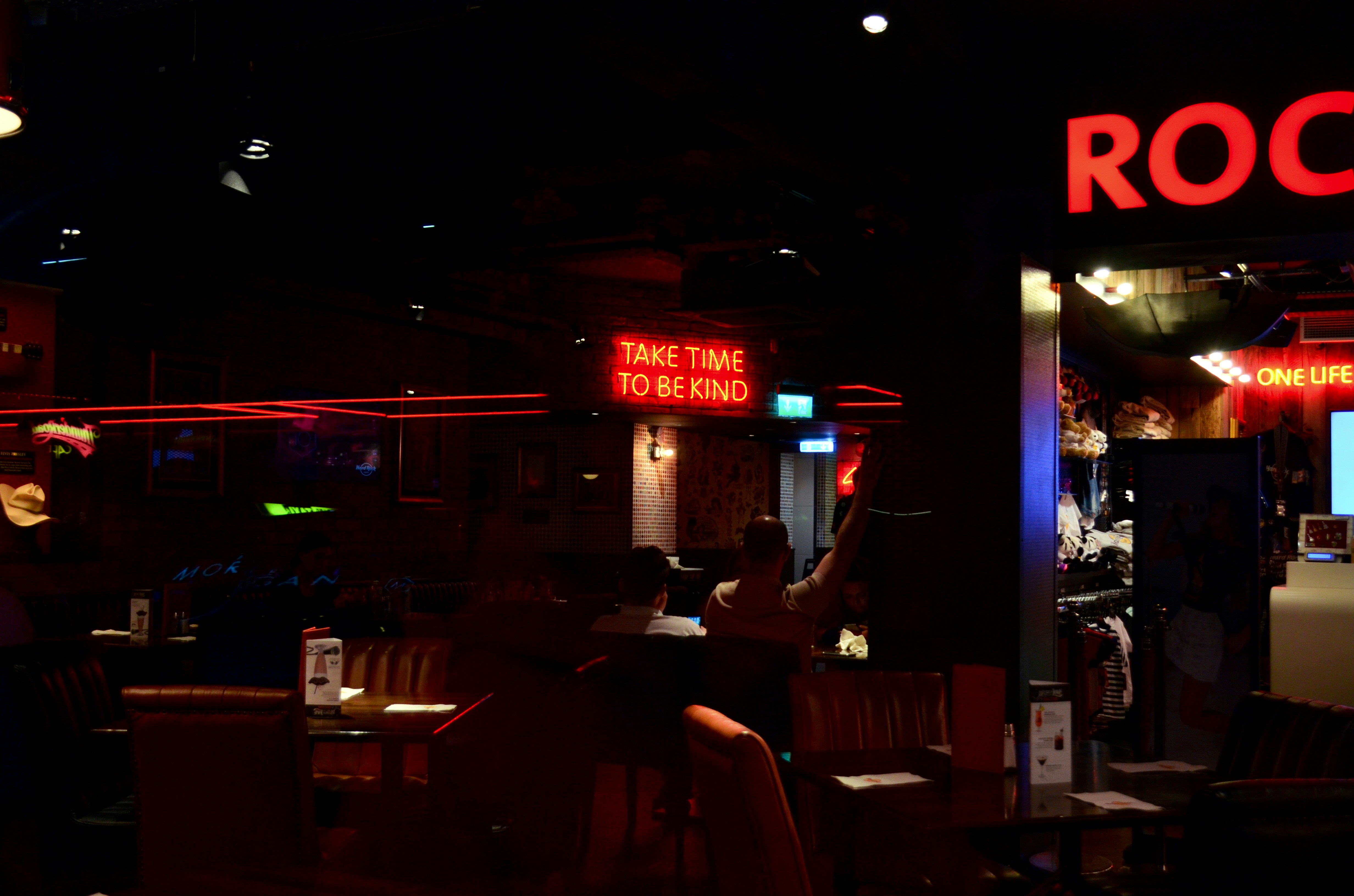 people sitting on chair near red and white store