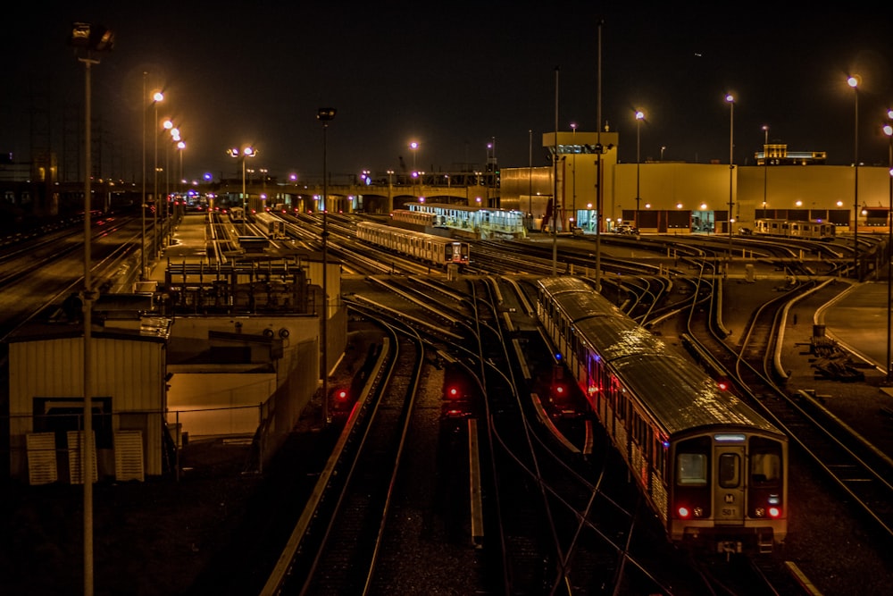 red and white train on rail during night time