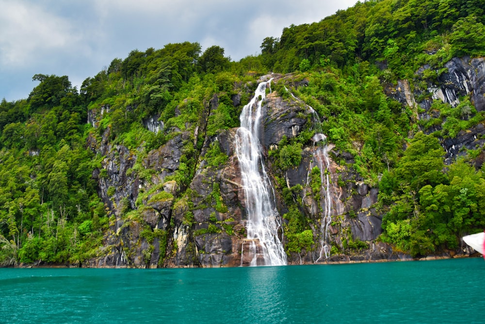 waterfalls on green and brown mountain