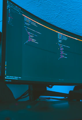 Developers collaborating over a large screen showing open-source code and live analytics data streams.