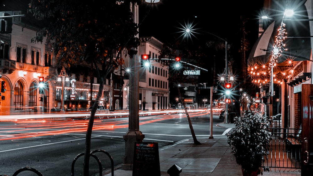 a city street filled with lots of traffic at night