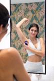 woman in white tank top smiling
