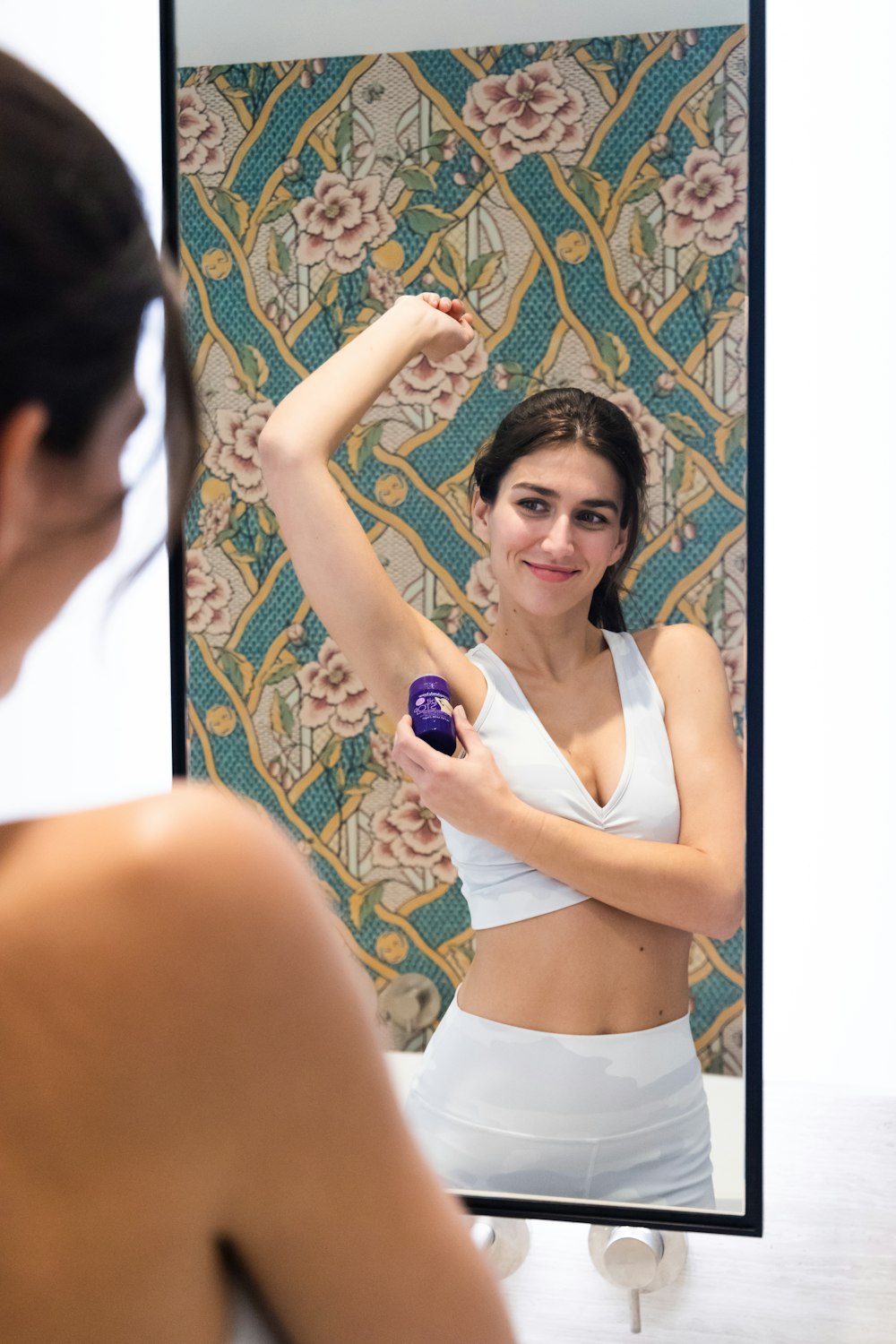 woman in white tank top smiling