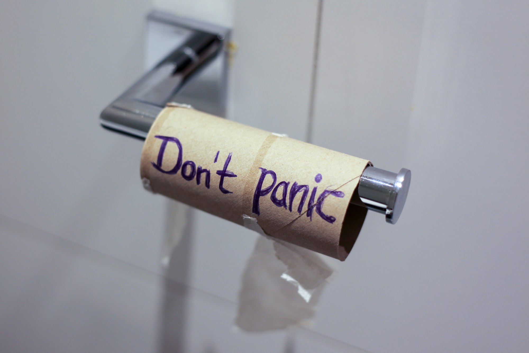 This photo was taken during the first lockdown (on 17. March 2020) in Munich, Germany due to the corona pandemic. I was seeing empty shelves in the supermarket, where once the toilet paper was piled up. The "German Angst" was symbolized by the hoarding of toilet paper. So when the toilet paper roll was finished I thought it would be uplifting/humorous to write "don't panic on the empty toilet roll". 

My title for it is "German Panic". 

This photo is my most successful photo in views and was featured in the Unsplash "COVID-19" compilation.
