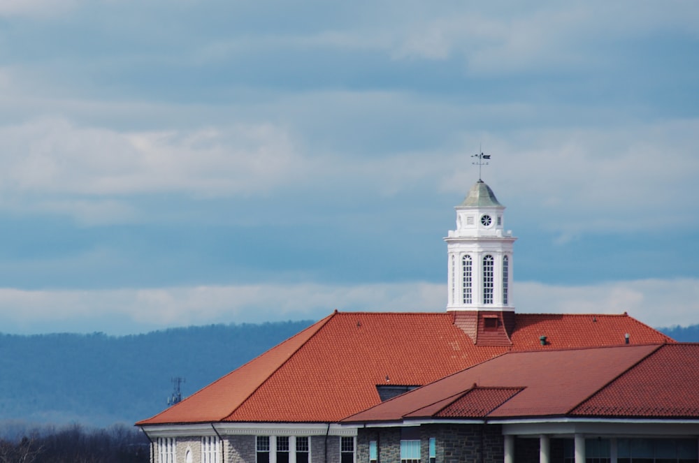 white and brown concrete building under white clouds during daytime