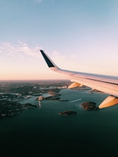 white airplane wing over the city during daytime