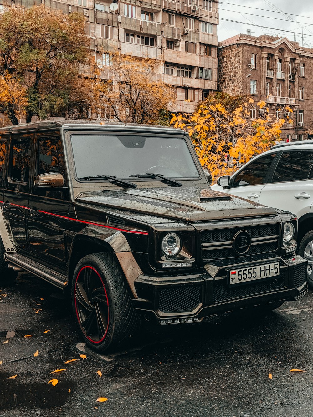 black mercedes benz g class suv parked on sidewalk during daytime