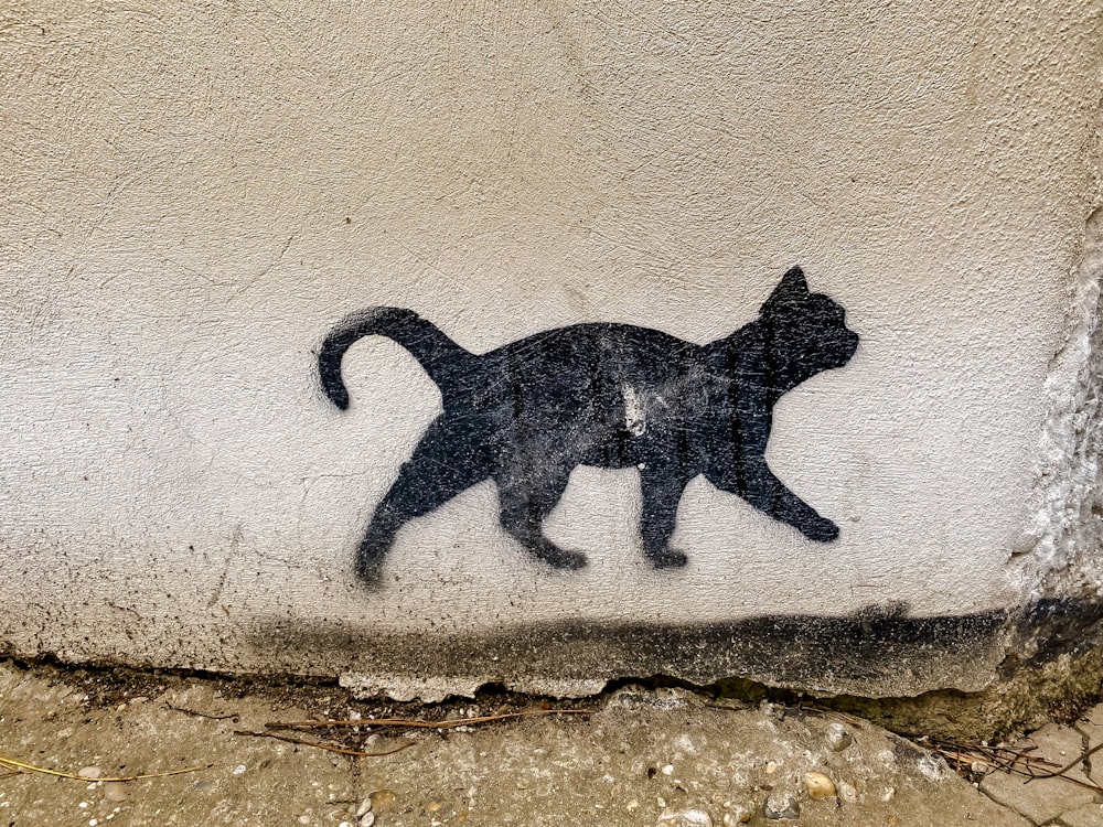 black cat wall art on brown concrete wall