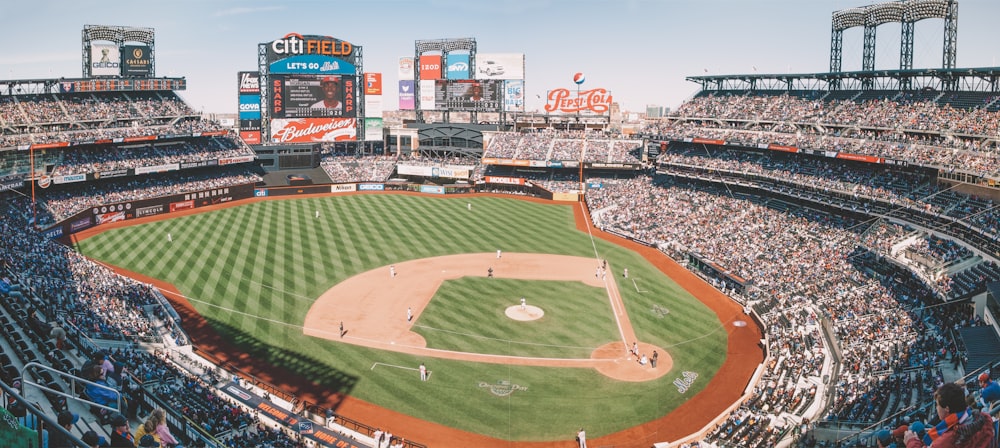 people watching baseball game during daytime