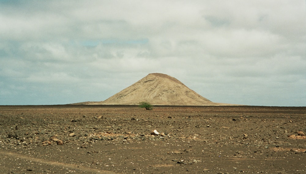 brown mountain under white clouds during daytime