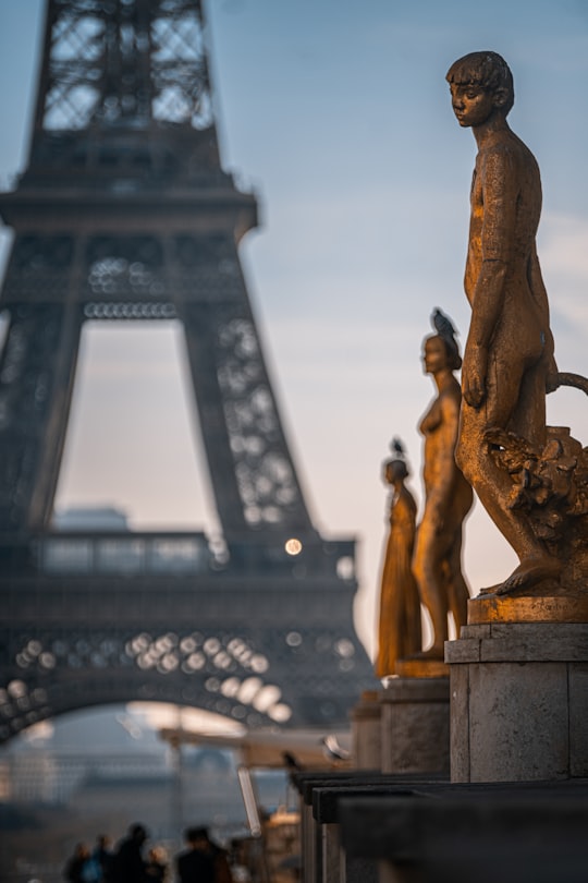 gold statue of man and woman in Trocadéro France