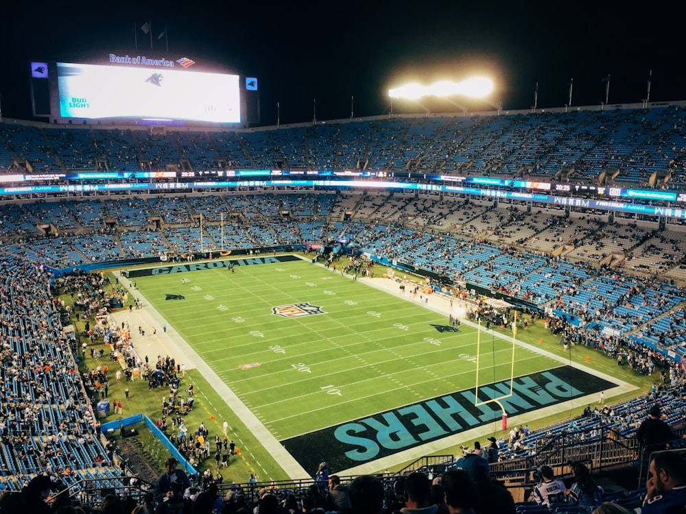 people watching football game during nighttime