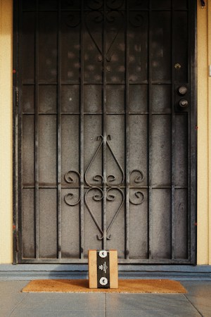 A black metal gate with a padlock, a reminder that a locked side gate or package box can keep deliveries safe at a Las Vegas home