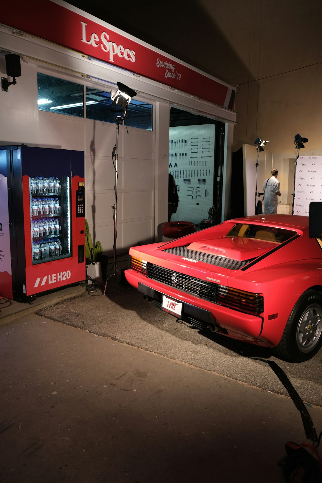 red car parked in front of store