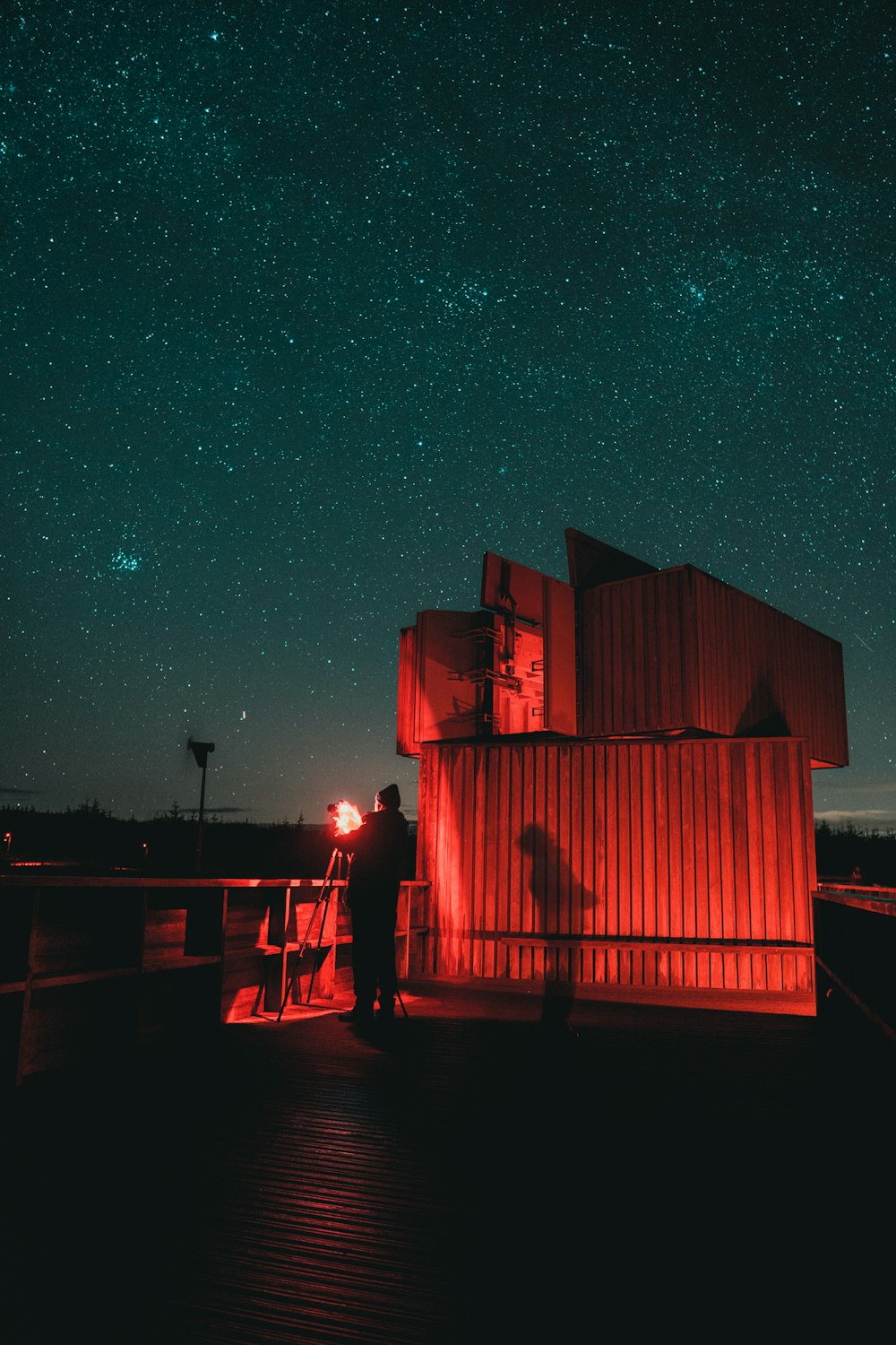 silhouette of 2 person standing on dock during night time