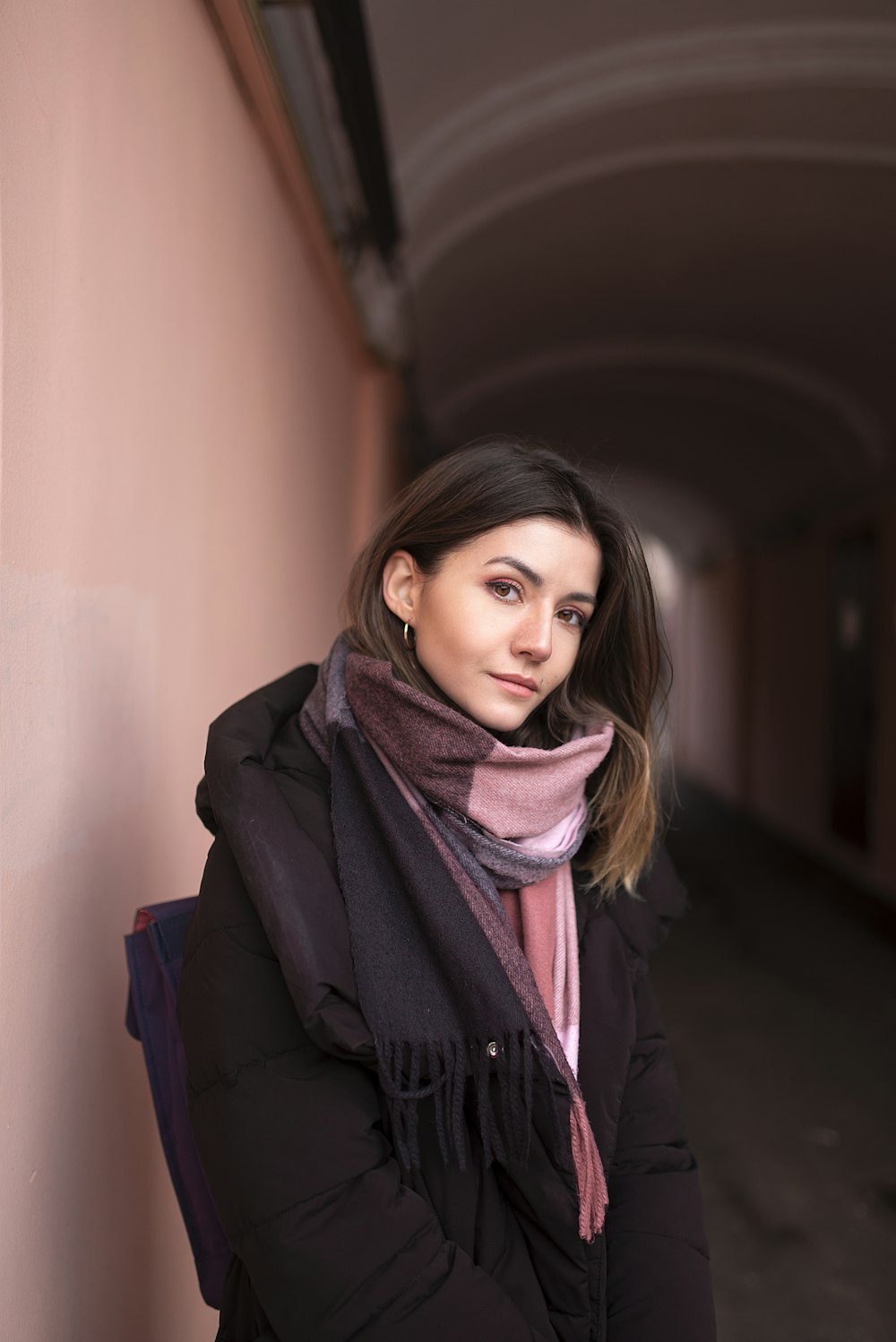 woman in black coat wearing brown scarf