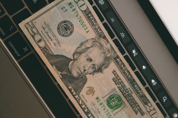 Photo of Andrew Johnson working at his desk with financial documents and a laptop.