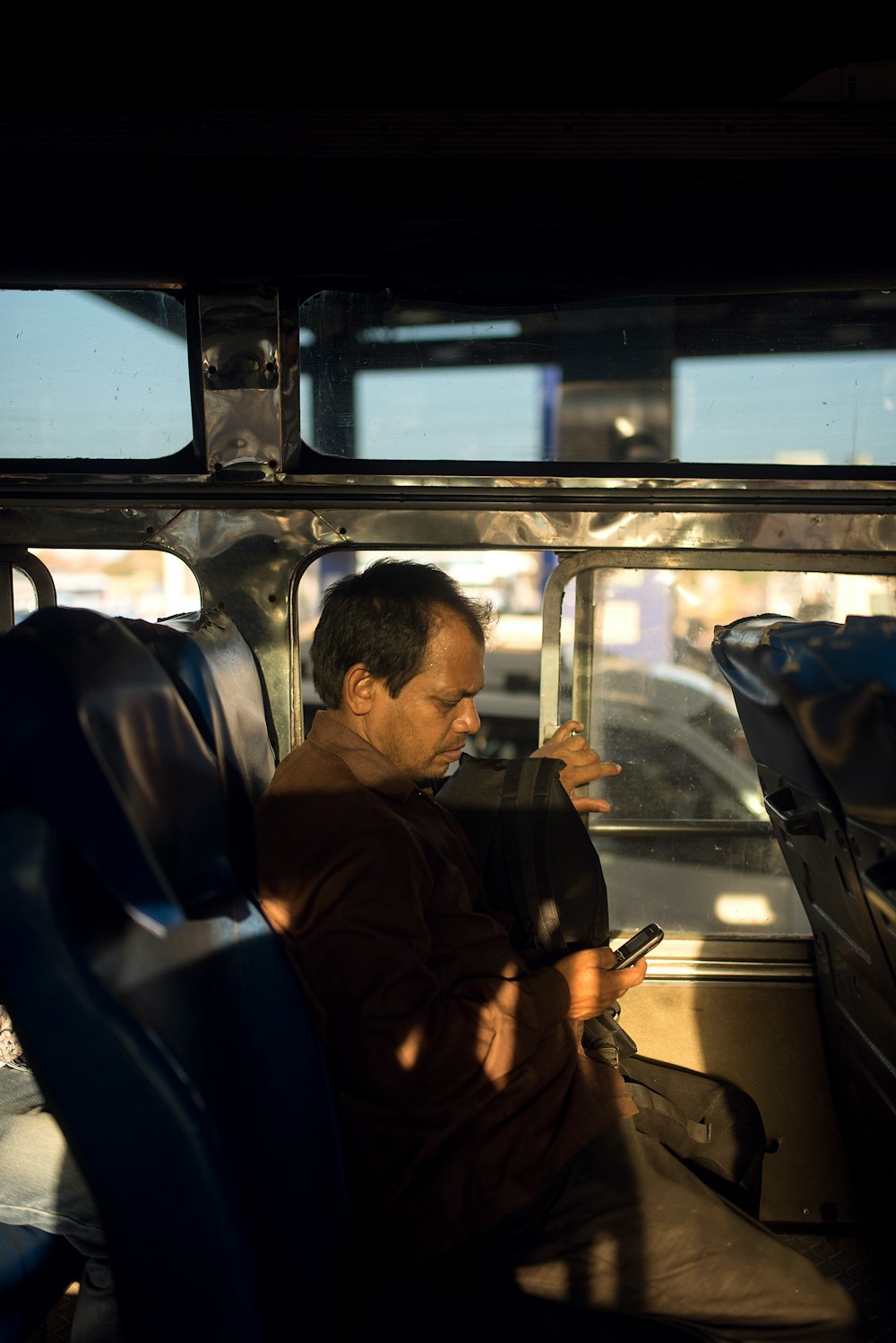 man in black jacket sitting on black car seat