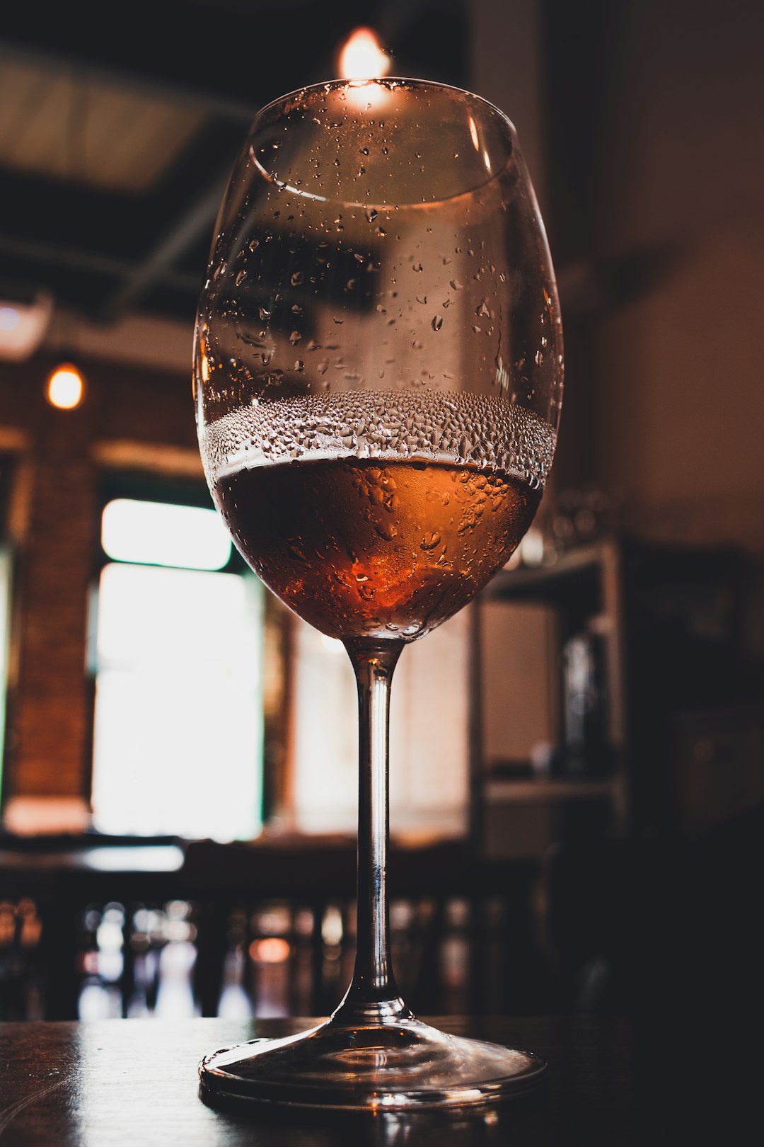 clear wine glass with brown liquid