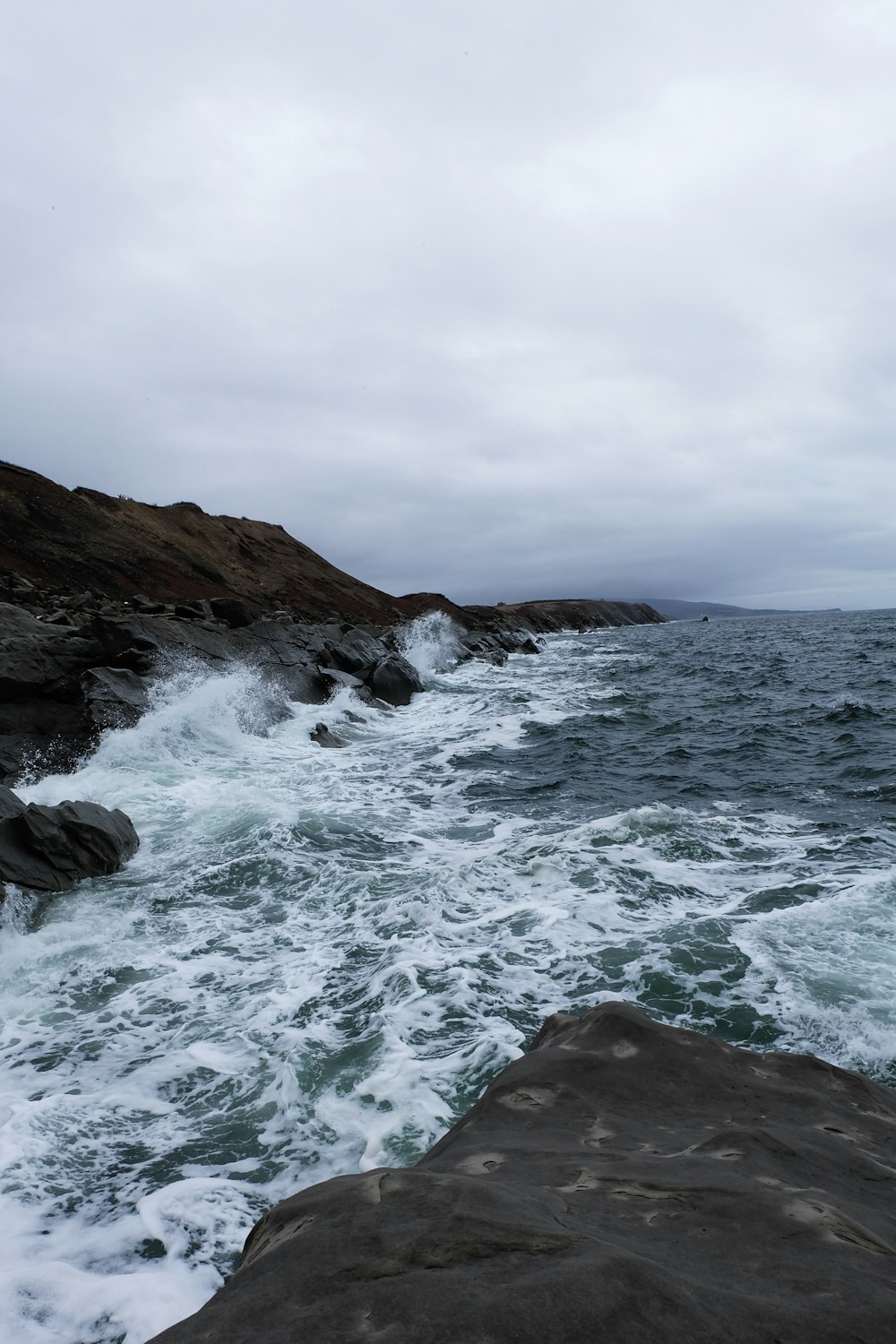 brown rock formation on sea water during daytime