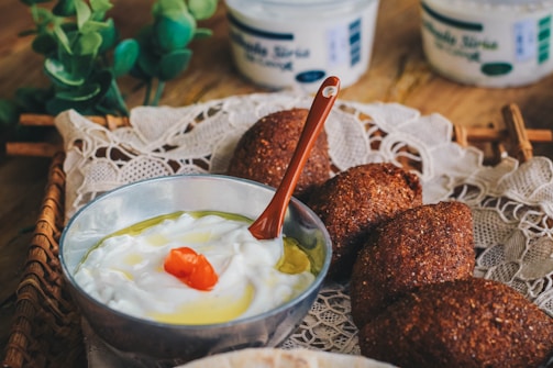 An elegant display of labneh served with fresh herbs and olive oil.