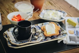 black ceramic mug on white ceramic plate