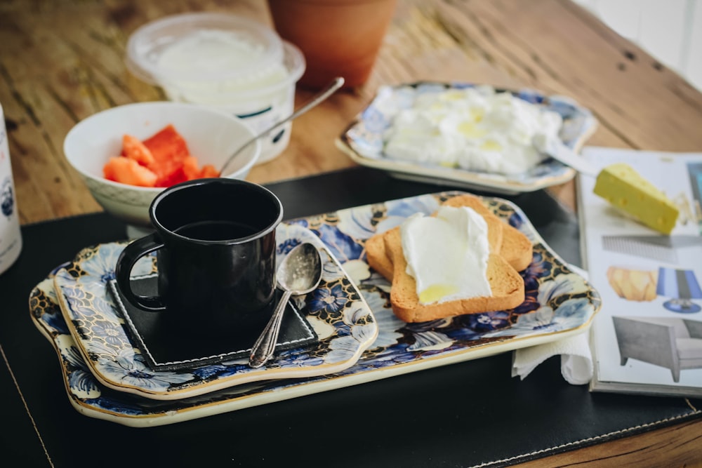 black ceramic mug on white ceramic plate