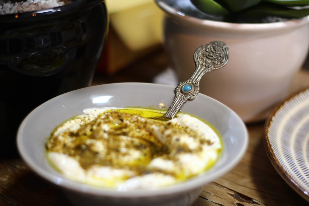 stainless steel spoon on white ceramic bowl