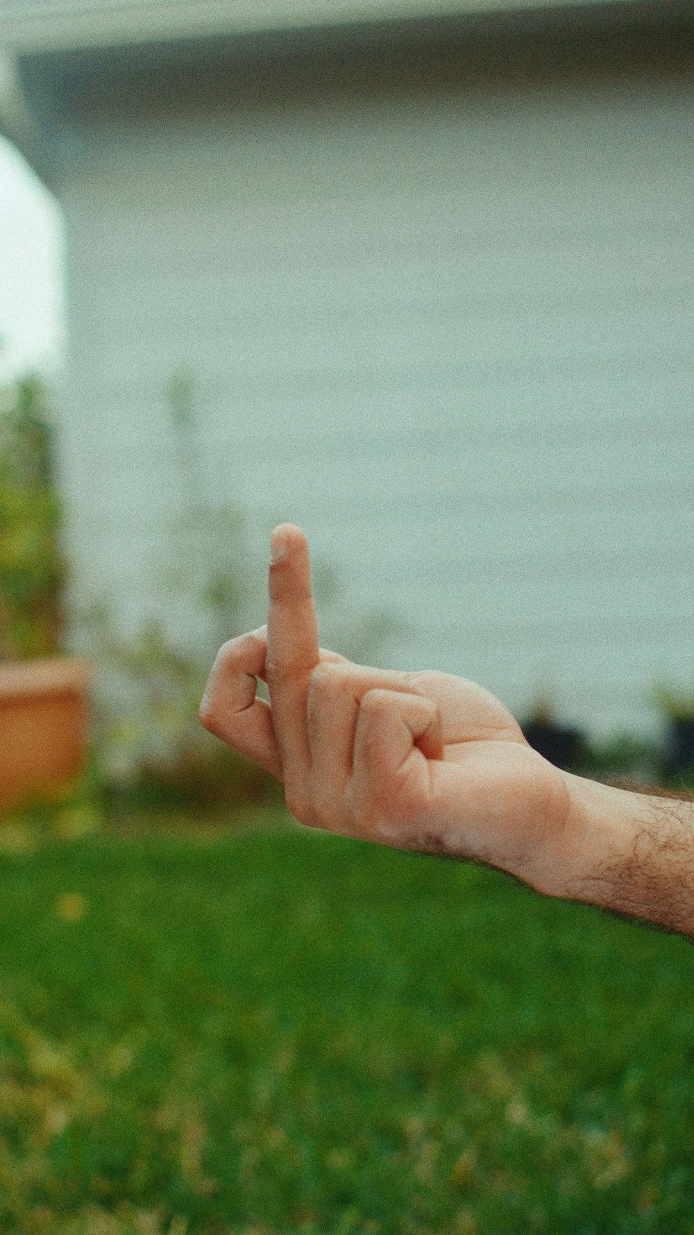 person showing right middle finger