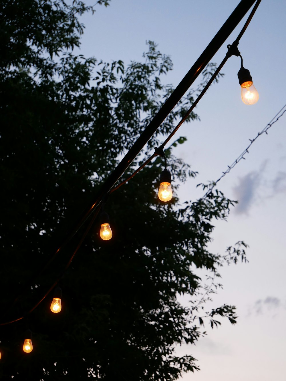 black metal post with string lights during night time